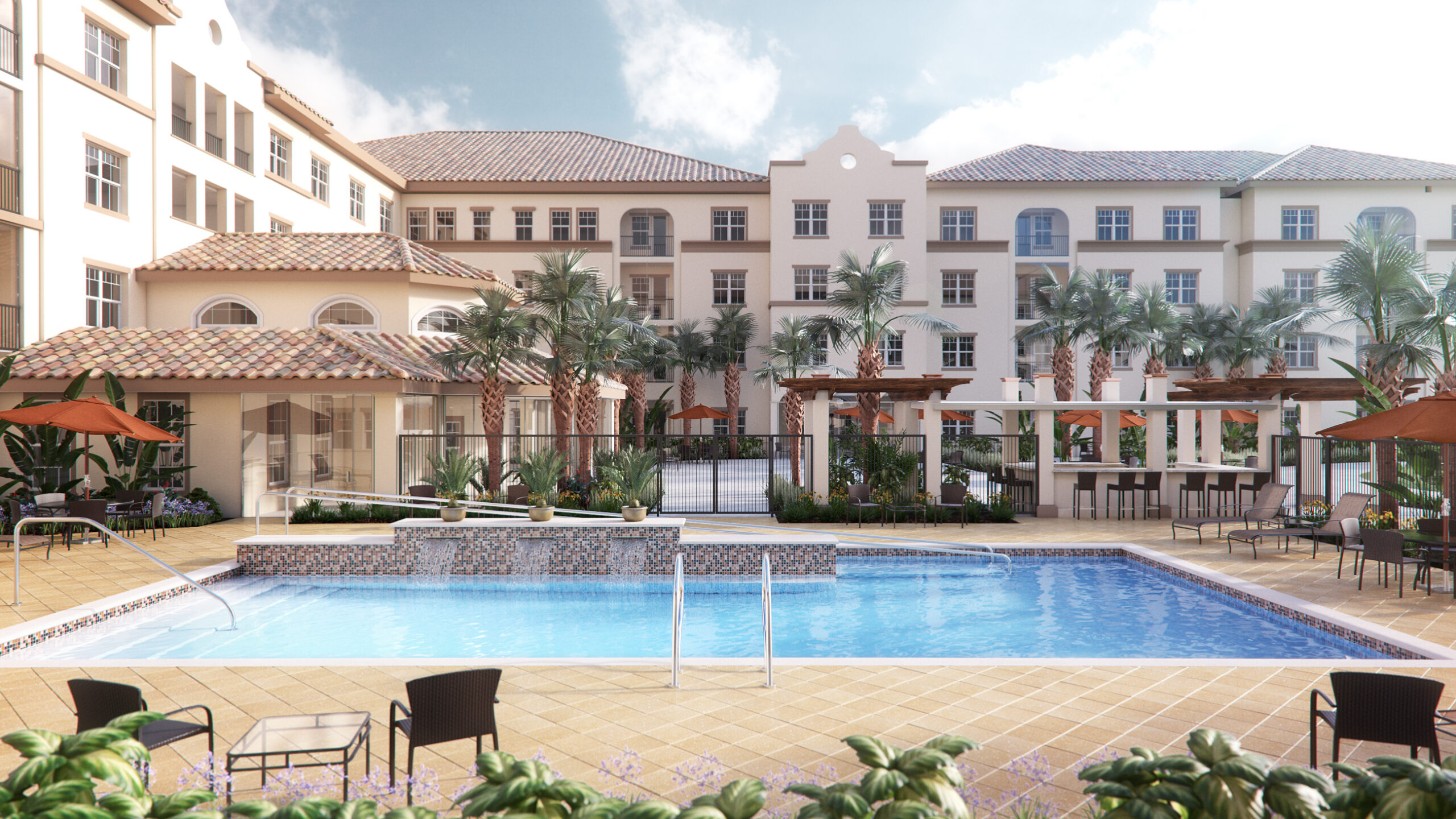 Resort pool area with palm trees, lounge chairs and umbrellas, bordered by beige stucco buildings with terracotta roofs behind.